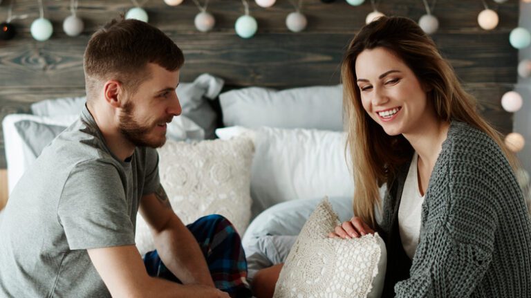 Person practicing a calming nighttime routine with dim lighting and a serene bedroom setting